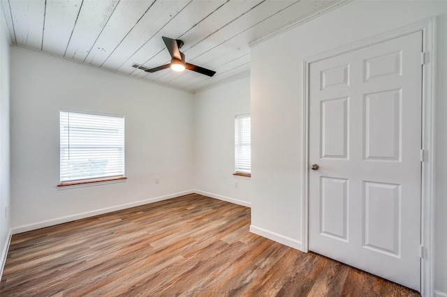 1505 W St, Mckinney, TX 75069 - empty room with healthy amount of natural light, ornamental molding, wood ceiling, wood finished floors, and ceiling fan