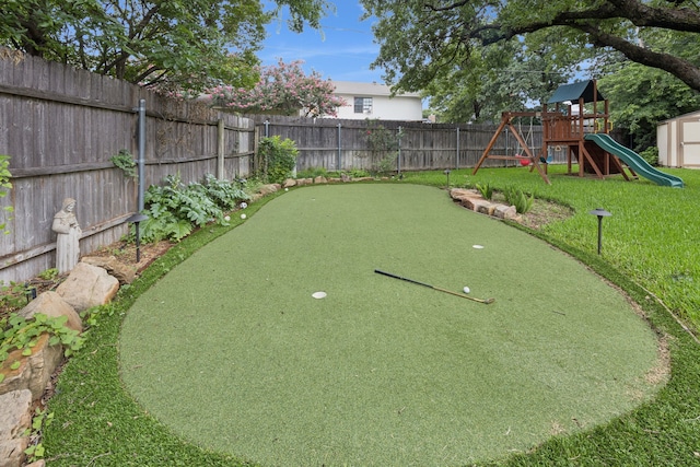 6209 Sierra Ct, Arlington, TX 76016 - fenced backyard featuring a putting green and a playground