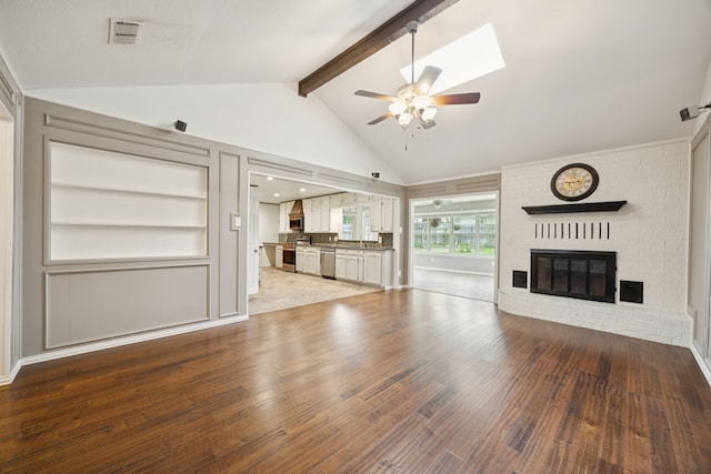 6209 Sierra Ct, Arlington, TX 76016 - unfurnished living room with a brick fireplace, wood finished floors, a ceiling fan, and built in shelves