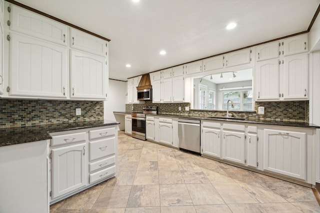6209 Sierra Ct, Arlington, TX 76016 - kitchen with appliances with stainless steel finishes, recessed lighting, decorative backsplash, and white cabinets