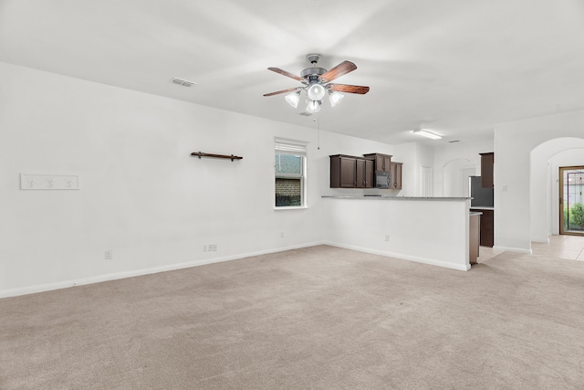 161 Collin St, Anna, TX 75409 - unfurnished living room with ceiling fan, light carpet, plenty of natural light, and arched walkways