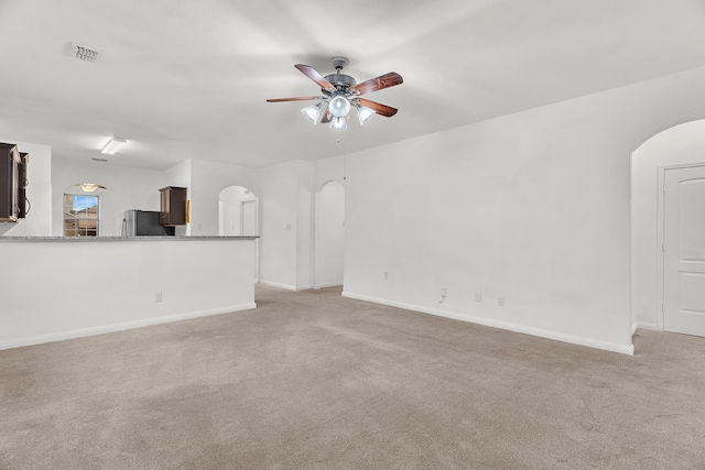 161 Collin St, Anna, TX 75409 - unfurnished living room with arched walkways, light colored carpet, and a ceiling fan