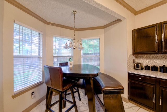 2315 Rockhill Rd, Mckinney, TX 75072 - dining room with a textured ceiling, a chandelier, plenty of natural light, and crown molding