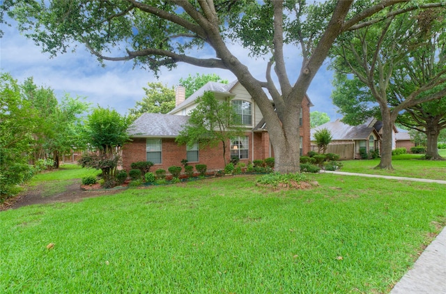 2315 Rockhill Rd, Mckinney, TX 75072 - view of front of property featuring a chimney, brick siding, and a front yard