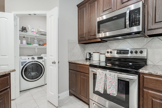 680 Navasota Dr, Crandall, TX 75114 - kitchen with appliances with stainless steel finishes, light tile patterned floors, decorative backsplash, light stone countertops, and dark brown cabinets