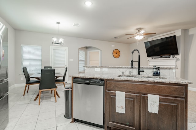 680 Navasota Dr, Crandall, TX 75114 - kitchen with stainless steel dishwasher, ceiling fan, dark brown cabinets, light tile patterned floors, and light stone countertops