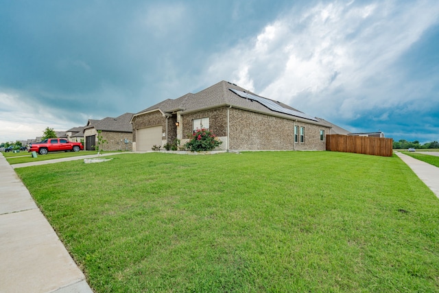 680 Navasota Dr, Crandall, TX 75114 - view of front of house featuring roof mounted solar panels, a garage, and brick siding