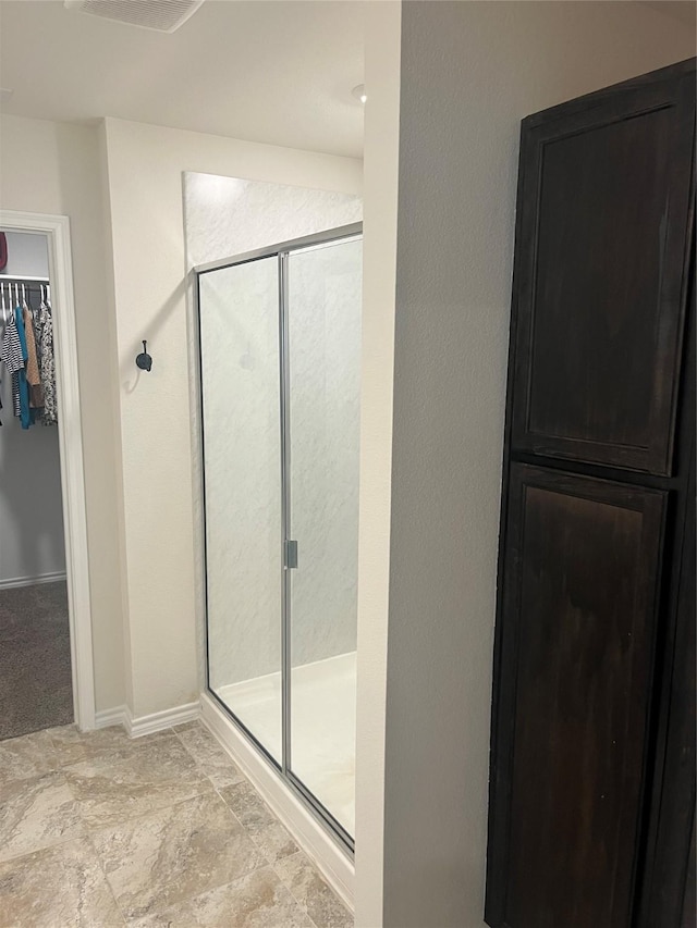 723 Primrose Ln, Pilot Point, TX 76258 - full bathroom featuring a stall shower and a walk in closet