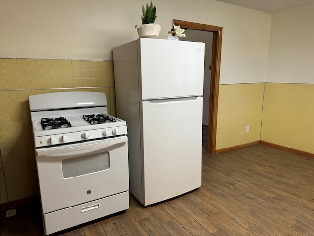 1402 Vine St, Bridgeport, TX 76426 - kitchen with white appliances, tile walls, dark wood finished floors, and wainscoting