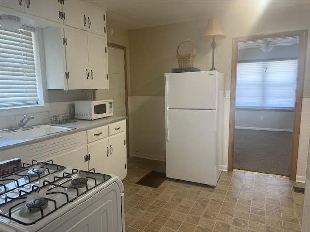 1402 Vine St, Bridgeport, TX 76426 - kitchen with white appliances, white cabinets, light countertops, and ceiling fan