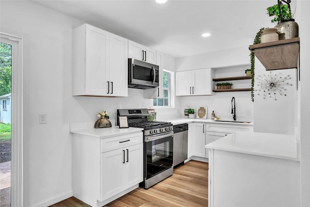 108 Fannin Dr, Euless, TX 76039 - kitchen featuring stainless steel appliances, open shelves, white cabinetry, light wood-type flooring, and light countertops