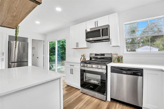 108 Fannin Dr, Euless, TX 76039 - kitchen featuring stainless steel appliances, light countertops, white cabinets, recessed lighting, and light wood-style flooring