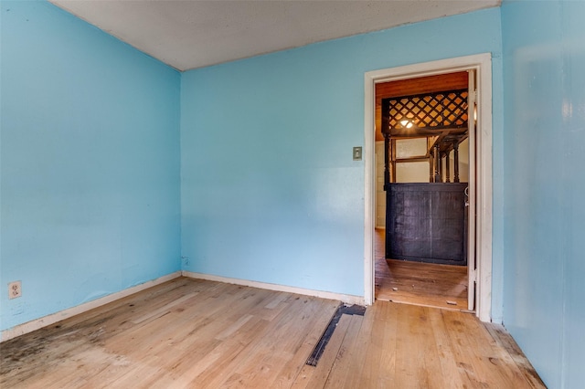 811 Tarryall Dr, Dallas, TX 75224 - empty room featuring wood finished floors and baseboards