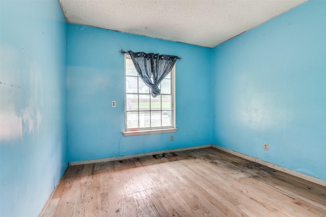 811 Tarryall Dr, Dallas, TX 75224 - unfurnished room with wood finished floors and a textured ceiling