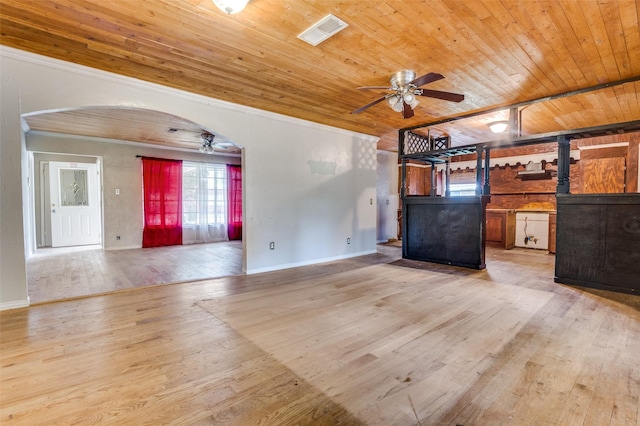 811 Tarryall Dr, Dallas, TX 75224 - unfurnished living room featuring ceiling fan, wood ceiling, light wood-style flooring, arched walkways, and crown molding