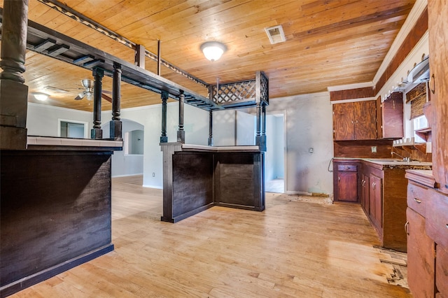 811 Tarryall Dr, Dallas, TX 75224 - kitchen featuring wooden ceiling, arched walkways, crown molding, light wood-type flooring, and open floor plan