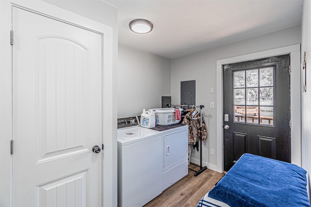 3135 Brazos River Dr, Granbury, TX 76048 - laundry room with washing machine and dryer, light wood-style floors, and electric panel