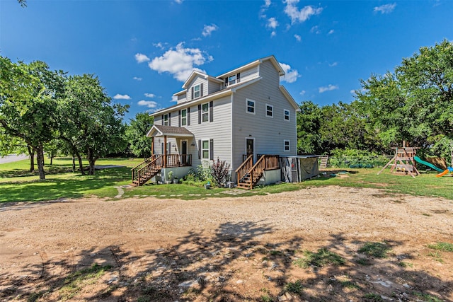 3135 Brazos River Dr, Granbury, TX 76048 - back of property with stairs, a playground, and a lawn