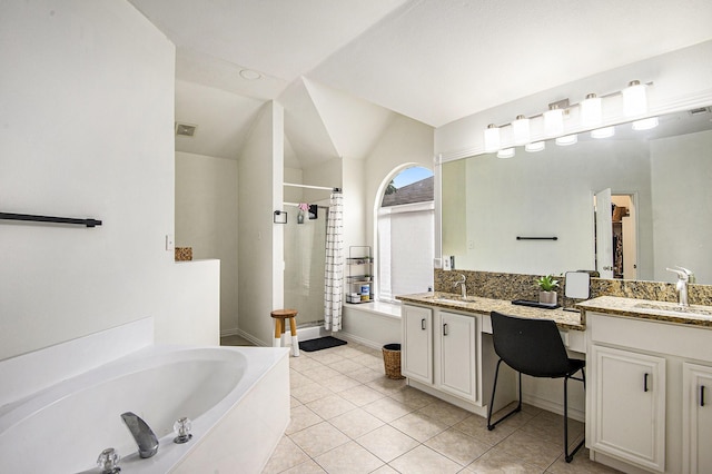 6833 Permian Ln, Fort Worth, TX 76137 - bathroom with a stall shower, a garden tub, double vanity, vaulted ceiling, and tile patterned floors
