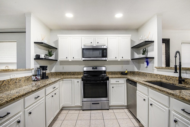 6833 Permian Ln, Fort Worth, TX 76137 - kitchen with open shelves, stainless steel appliances, white cabinetry, dark stone countertops, and ornamental molding