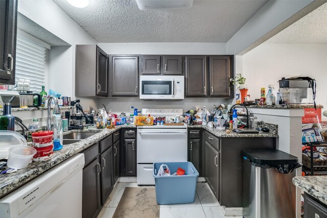 1612 Hackamore St, Mesquite, TX 75149 - kitchen with white appliances, a textured ceiling, and light stone countertops