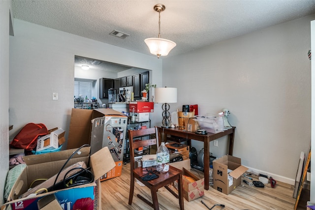 1612 Hackamore St, Mesquite, TX 75149 - dining space featuring light wood finished floors and a textured ceiling