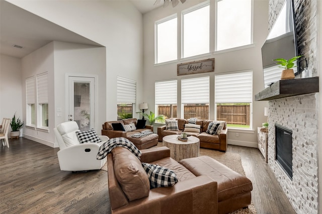 3900 Brazoria Dr, Prosper, TX 75078 - living room featuring a high ceiling, a fireplace, wood finished floors, and plenty of natural light