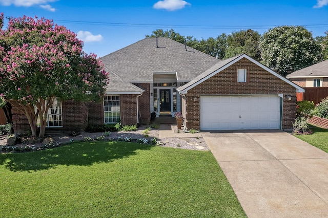 2705 Willowood Dr, Grapevine, TX 76051 - view of front of property featuring brick siding, a front lawn, a shingled roof, and driveway