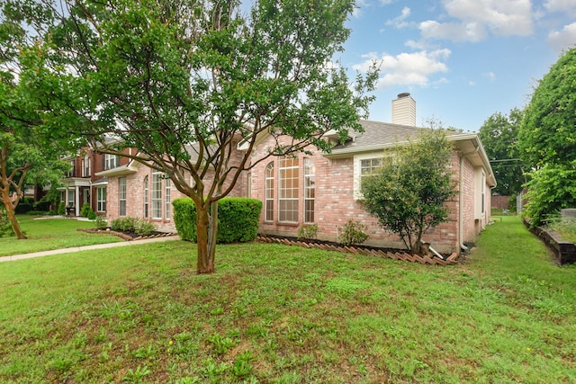 2515 High Pointe Blvd, Mckinney, TX 75071 - view of front facade featuring brick siding, a chimney, and a front yard