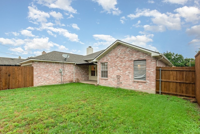 2515 High Pointe Blvd, Mckinney, TX 75071 - back of house with brick siding, a fenced backyard, a chimney, a shingled roof, and a patio area