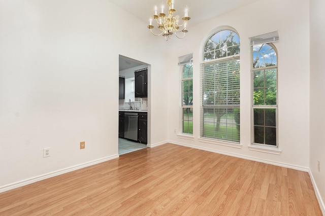 2515 High Pointe Blvd, Mckinney, TX 75071 - spare room with a chandelier and light wood finished floors