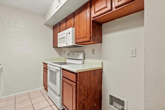 11460 Audelia Rd Unit 172, Dallas, TX 75243 - kitchen with white appliances, light tile patterned floors, light countertops, and brown cabinets