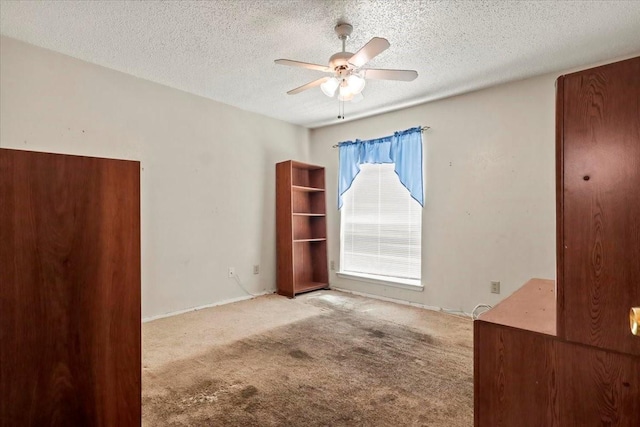 11460 Audelia Rd Unit 172, Dallas, TX 75243 - unfurnished bedroom featuring carpet, a textured ceiling, and a ceiling fan