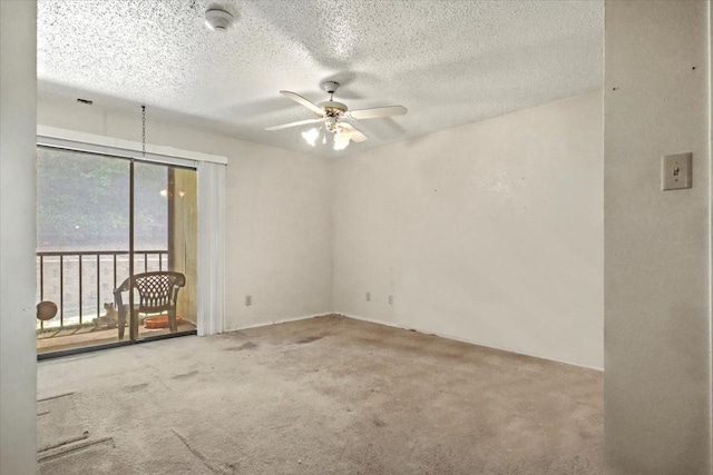 11460 Audelia Rd Unit 172, Dallas, TX 75243 - spare room with ceiling fan, carpet flooring, a smoke detector, and a textured ceiling