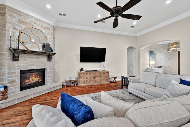 2427 Remuda Dr, Sherman, TX 75092 - living area with wood finished floors, crown molding, ceiling fan, arched walkways, and a stone fireplace