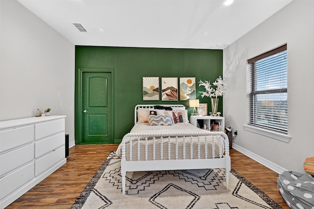2427 Remuda Dr, Sherman, TX 75092 - bedroom with an accent wall, wood finished floors, and recessed lighting