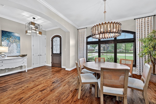 2427 Remuda Dr, Sherman, TX 75092 - dining space with a chandelier, wood finished floors, ornamental molding, and arched walkways