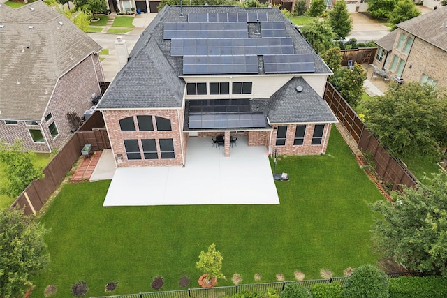 6873 Martel Pl, Frisco, TX 75035 - rear view of property featuring brick siding, a fenced backyard, solar panels, and a shingled roof