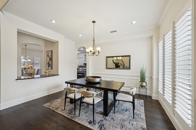6873 Martel Pl, Frisco, TX 75035 - dining area with arched walkways, wood finished floors, a chandelier, ornamental molding, and recessed lighting