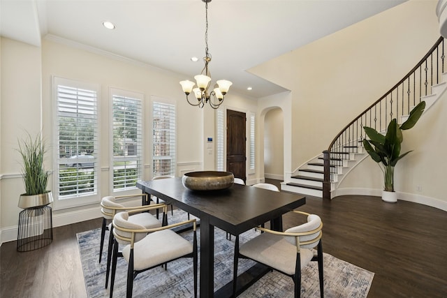 6873 Martel Pl, Frisco, TX 75035 - dining space featuring a chandelier, stairs, arched walkways, dark wood-style flooring, and crown molding