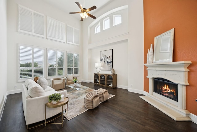 6873 Martel Pl, Frisco, TX 75035 - living area featuring a high ceiling, a ceiling fan, a glass covered fireplace, and wood finished floors
