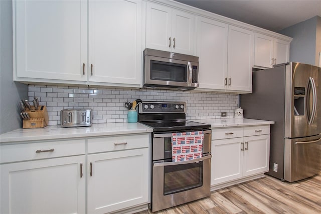 5216 Copper Creek Dr, Fort Worth, TX 76244 - kitchen with stainless steel appliances, white cabinets, light wood-style flooring, and backsplash