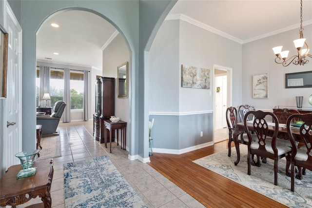 3217 S Bay Breeze Ln, Fort Worth, TX 76179 - dining room with a chandelier, arched walkways, ornamental molding, light tile patterned floors, and recessed lighting