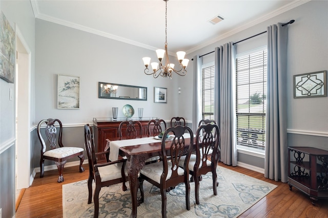 3217 S Bay Breeze Ln, Fort Worth, TX 76179 - dining space featuring crown molding, a chandelier, and wood finished floors
