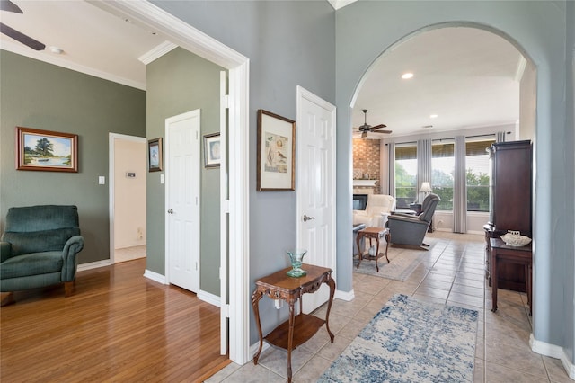 3217 S Bay Breeze Ln, Fort Worth, TX 76179 - hall featuring arched walkways, crown molding, a high ceiling, and light wood-type flooring