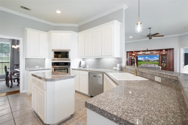 3217 S Bay Breeze Ln, Fort Worth, TX 76179 - kitchen featuring appliances with stainless steel finishes, a ceiling fan, tasteful backsplash, hanging light fixtures, and white cabinets