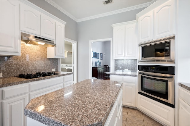 3217 S Bay Breeze Ln, Fort Worth, TX 76179 - kitchen featuring appliances with stainless steel finishes, under cabinet range hood, backsplash, white cabinets, and crown molding