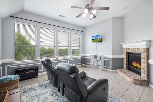3217 S Bay Breeze Ln, Fort Worth, TX 76179 - living room featuring a fireplace, tile patterned flooring, a ceiling fan, vaulted ceiling, and wainscoting