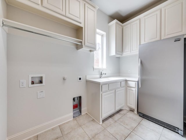 2911 Blackthorn Dr, Prosper, TX 75078 - laundry area featuring hookup for a washing machine, cabinet space, hookup for an electric dryer, light tile patterned floors, and gas dryer hookup