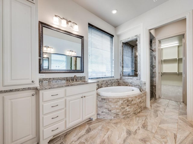 2911 Blackthorn Dr, Prosper, TX 75078 - full bath with vanity, a bath, marble finish floors, a shower, and a spacious closet